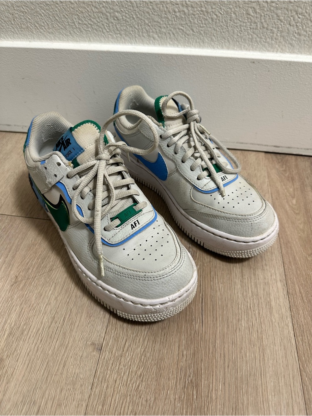 Nike Low-Top Sneakers in White with Blue and Green Swooshes
